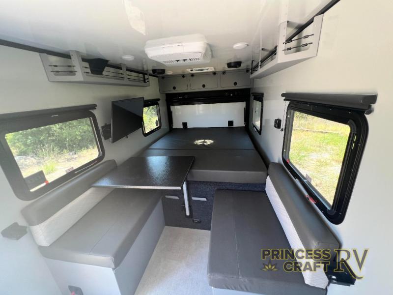 Sleeping area with dinette in ROG 16RB By Encore RV